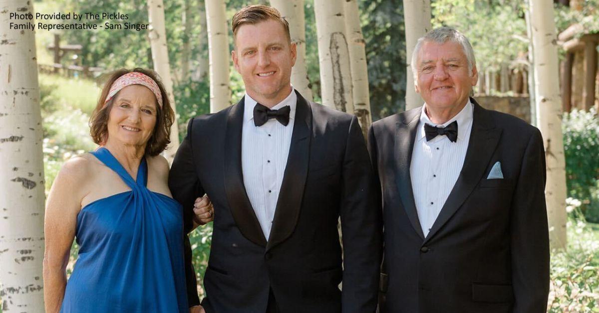 Josh Pickles with his two parents in formal attire. 