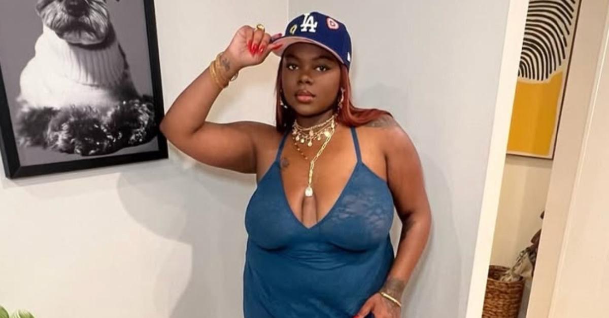 Cori Broadus posing with a baseball cap.