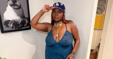 Cori Broadus posing with a baseball cap.