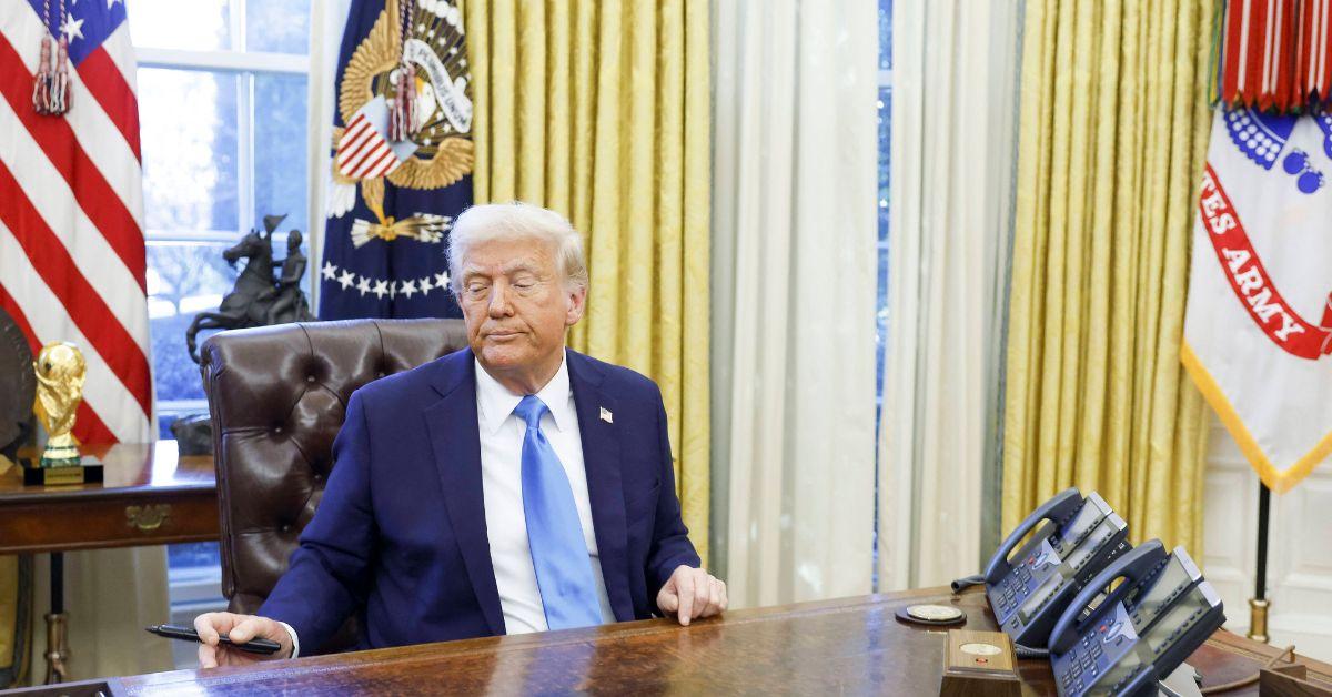 Donald Trump sitting at his desk in the Oval Office. 