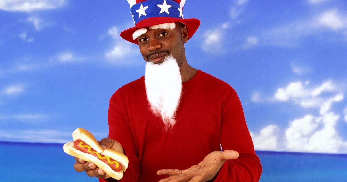 Man in Uncle Sam costume with hot dog