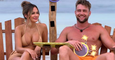 Jess and Harry sit in chairs on the beach on Perfect Match