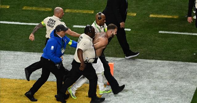 One of the streakers being led off the field at Super Bowl LVIII in Las Vegas