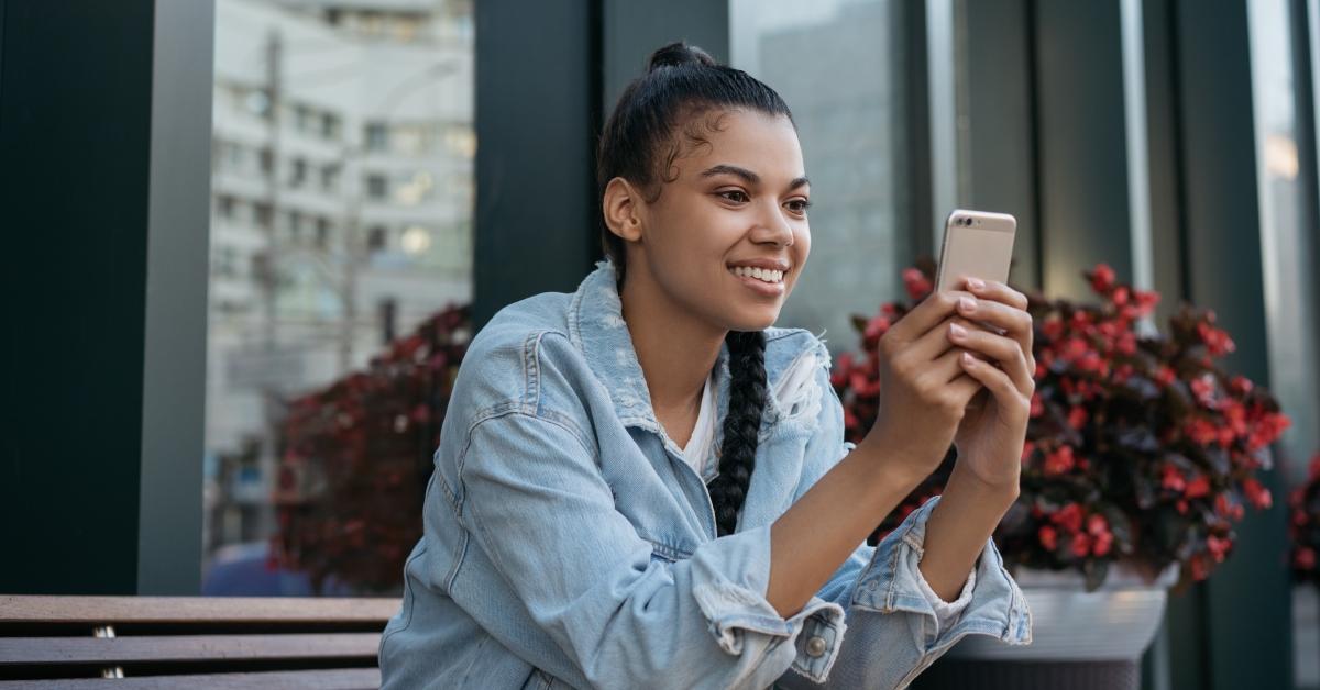 woman smiling looking at phone