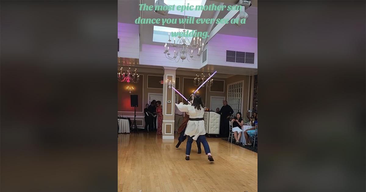 A mother and son during their lightsaber dance at his wedding