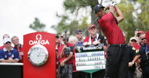 Tiger Woods sporting a red shirt while competiting in a golf tournament.