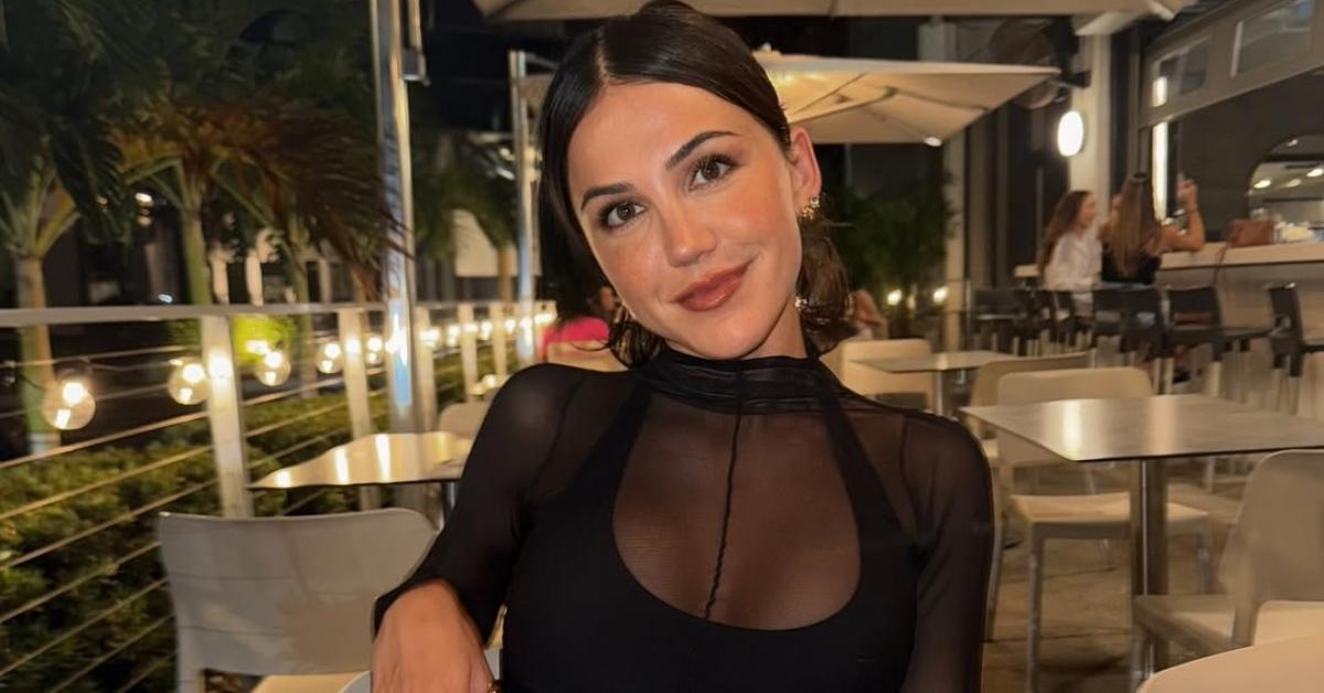 Kat Stickler sits at an outdoor table at a restaurant.