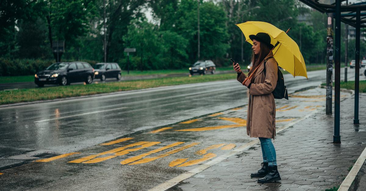 woman in the rain looking at her phone