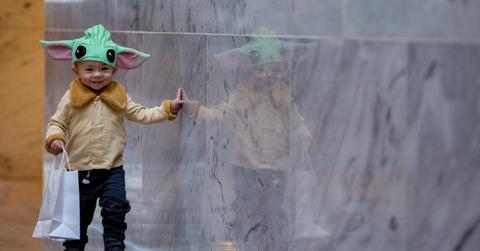 young boy wearing a yoda costume