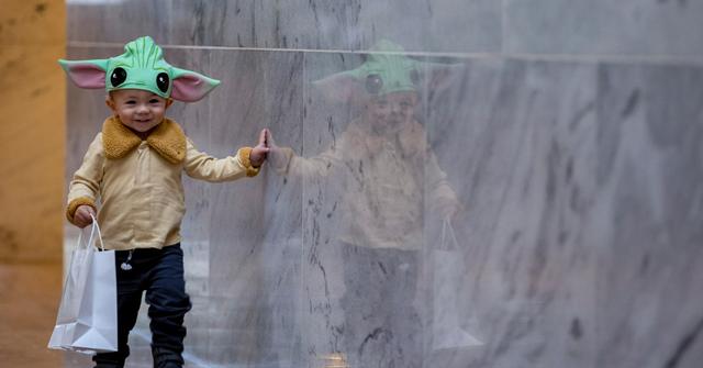 young boy wearing a yoda costume