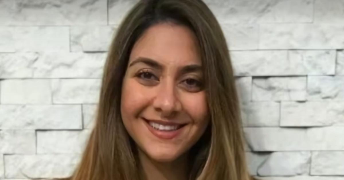 Shireen Afkari, the woman arrested for the bar fight, against a white brick wall.