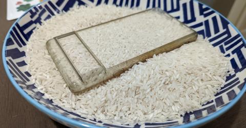 Cell phone case in bowl of white rice