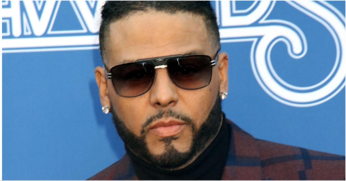 Al B. Sure!’s posing for a press photo in sunglasses