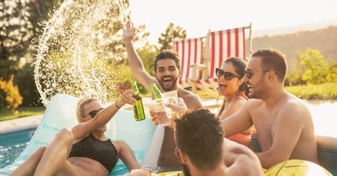Adults drinking and having fun at a pool party