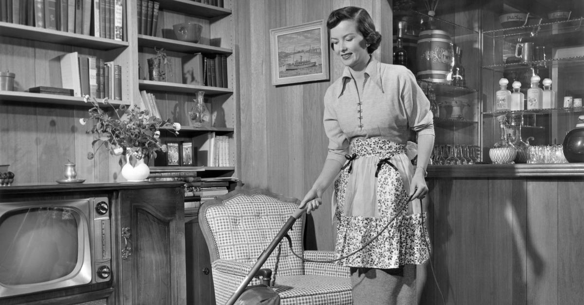 A 1950s housewife vacuuming