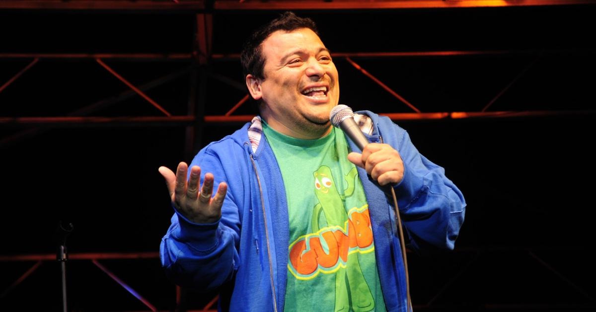 Carlos Mencia performing on stage in 2010.