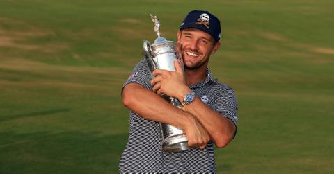 Bryson DeChambeau of The United States cradles the U.S.Open trophy after his win in the final round of the 2024 U.S. Open Championship