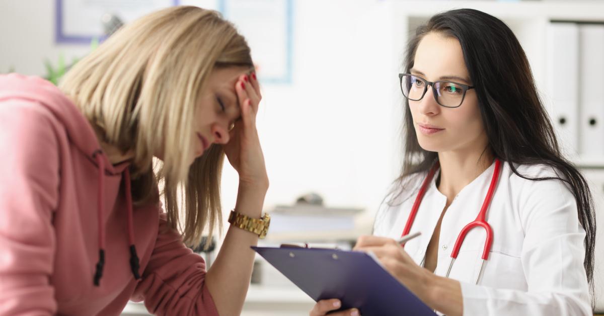 A woman is stressed during a doctor's appointment.