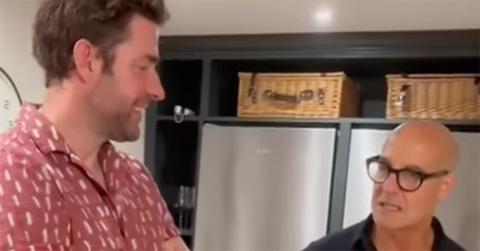 John Krasinski and Stanley Tucci in a kitchen.