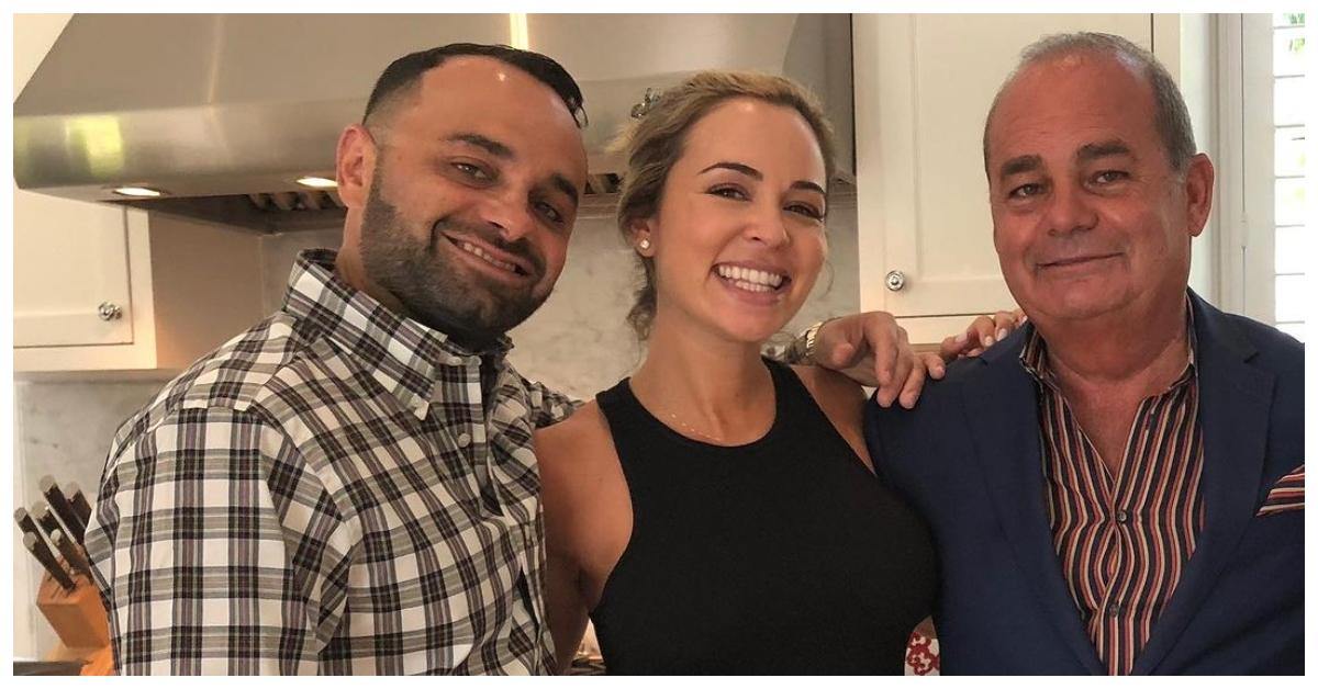 (l-r): Nicole Martin's brother, her, and her father smiling in a kitchen