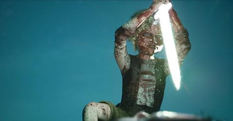 Main character Olle using a sword of light in Bramble and the Mountain King