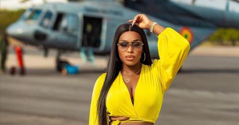 Quad in a yellow shirt near a helicopter