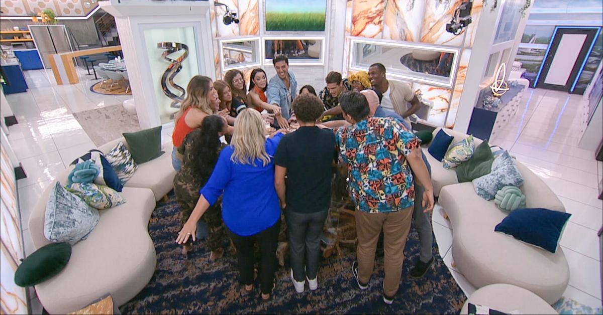 The cast of 'Big Brother 26' puts their hand together in celebration.