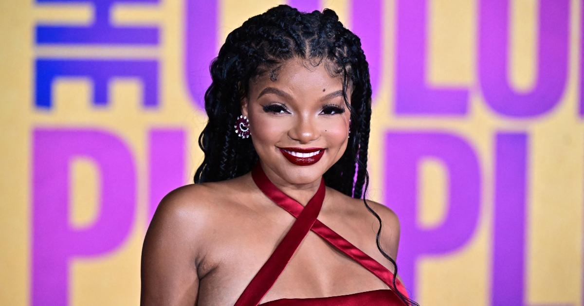 Halle Bailey attends 'The Color Purple' premiere in a flowing red dress.