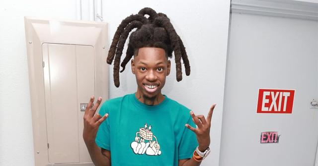 Julio Foolio in front of an exit sign.