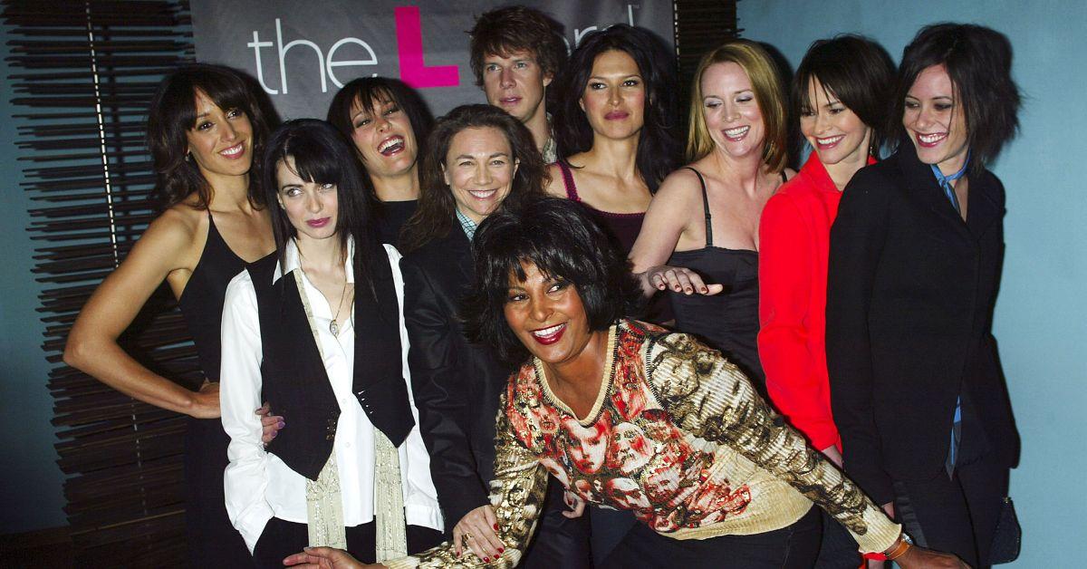 'The L Word' cast posing and smiling together in a group.
