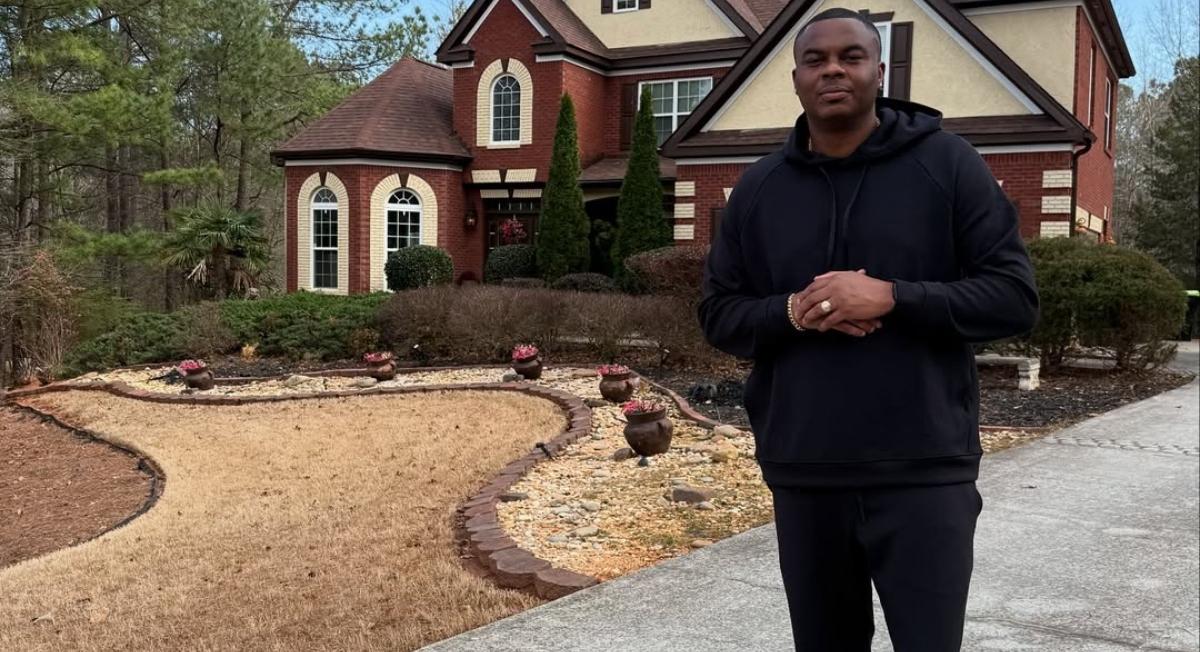 Moe Mitchell in front of his house.