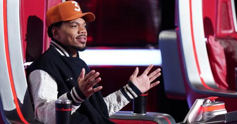 Chance the Rapper sitting in a judge chair on Season 25 of 'The Voice'.