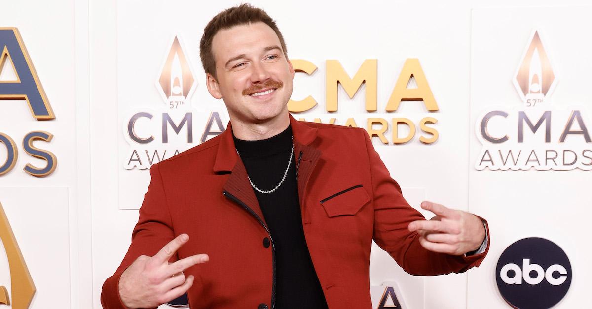  Morgan Wallen in a red jacket, smiling, at the 2023 CMA Awards at Bridgestone Arena on Nov. 8, 2023 