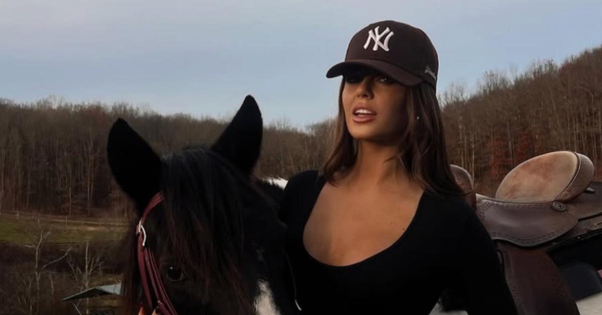 Brittany Williams posing with a horse.