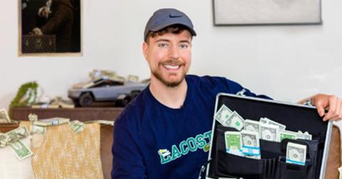 MrBeast holding a briefcase full of cash.