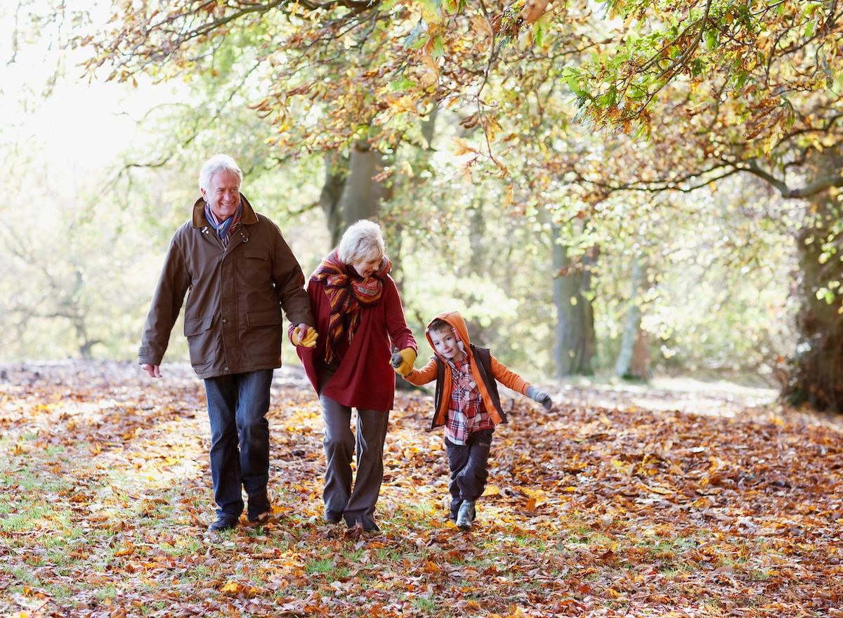 Grandparents spending time with their grandson in the fall