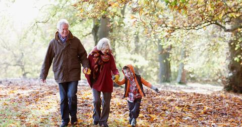 Grandparents spending time with their grandson in the fall
