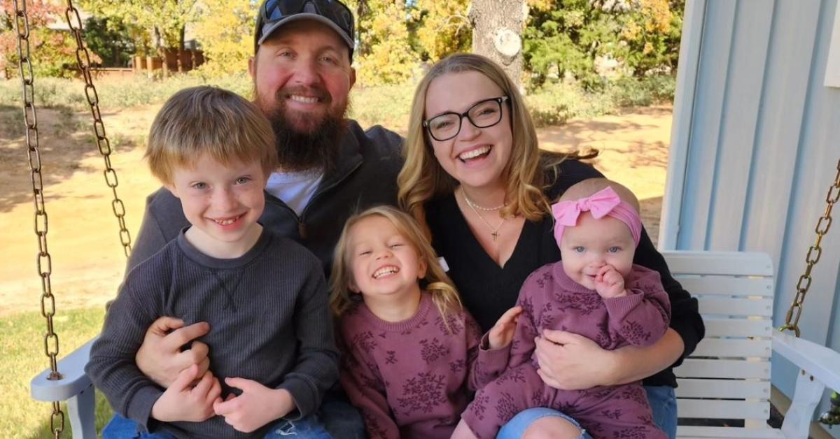 Maddie Brush with her husband and their kids on their porch swing