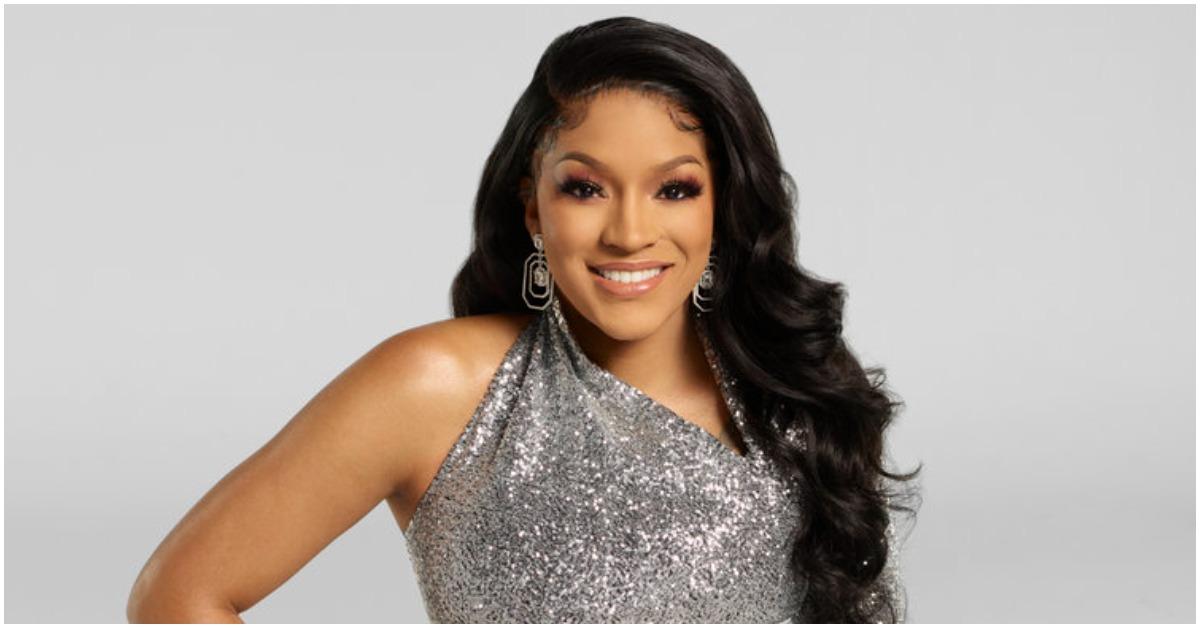 Drew Sidora smiling in her 'RHOA' Season 14 promotional photo.