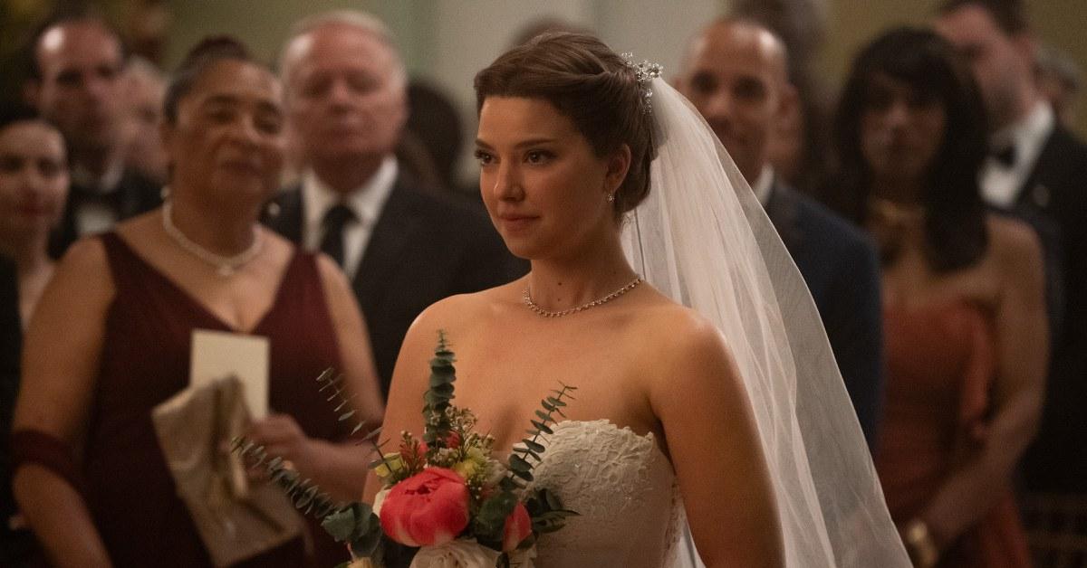 Bree walking down the aisle in her wedding dress.