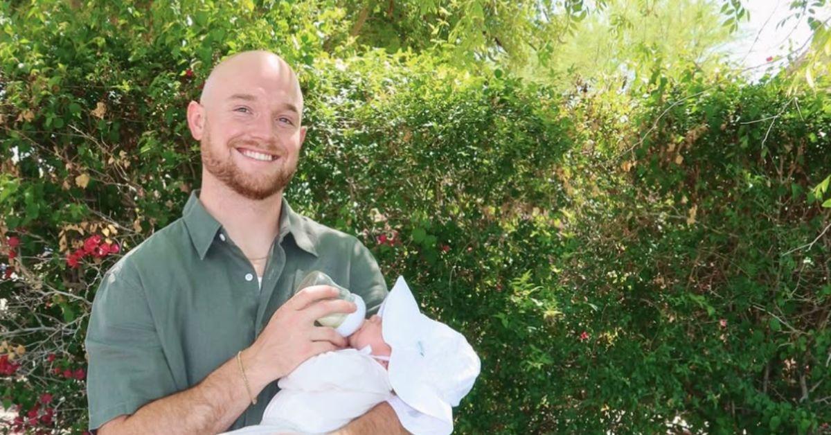 Brady Kiser holding his young baby Theodore.