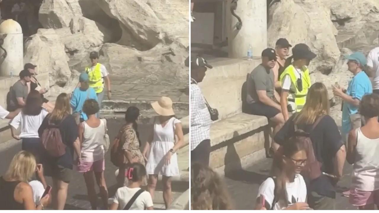 An officer confronts the tourist at the Trevi Fountain