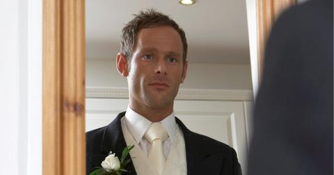 groom looking in mirror