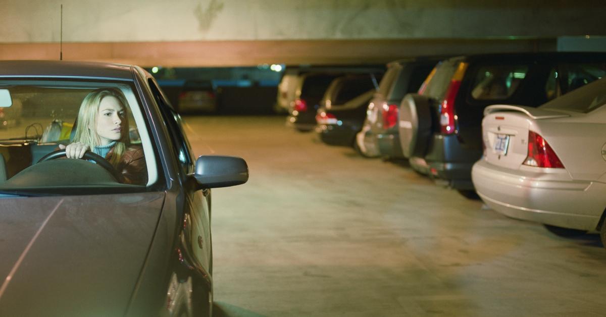 woman in car in parking garage