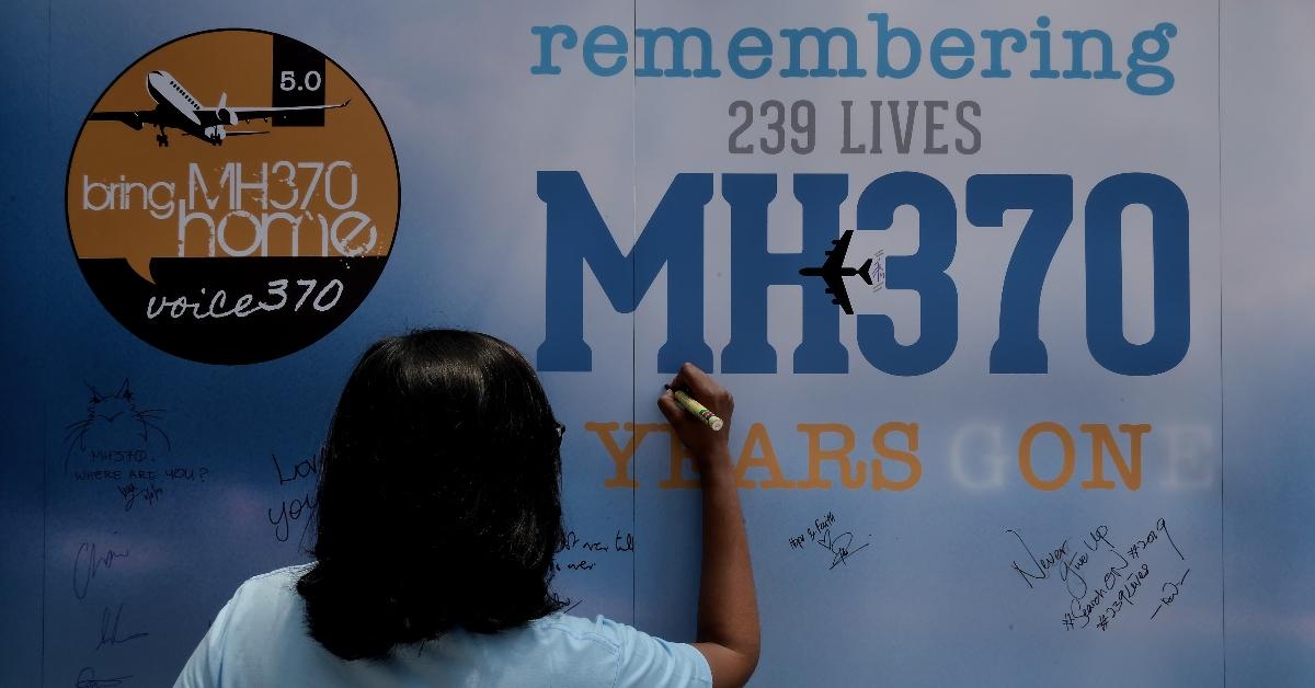 KUALA LUMPUR, MALAYSIA - MARCH 03: A family member writes on a message board for passengers, onboard the missing Malaysia Airlines Flight MH370 during a 5 Years of Remembrance for Malaysian Airlines MH370 event on March 3, 2019 in Kuala Lumpur, Malaysia. The Boeing 777-200 plane heading from Kuala Lumpur to Beijing with 239 passengers and crew went missing on March 8, 2014. According to Malaysias transport minister Anthony Loke, government is waiting for a fresh proposal from US exploration firm Ocean Infinity or any other interested party before resuming the search for ill-fated flight MH370, five years after tragedy the Malaysian Airlines MH370 flight still on mysery. (Photo by Mohd Samsul Mohd Said/Getty Images)