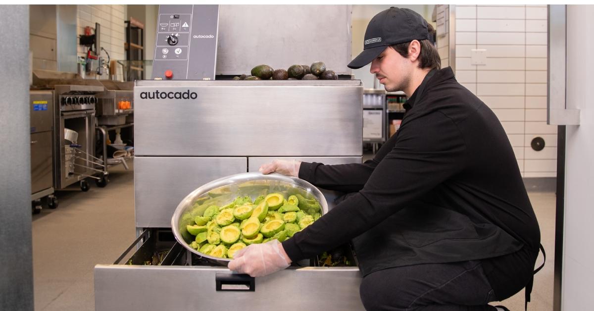 A chipotle worker using the autocado guacamole robot