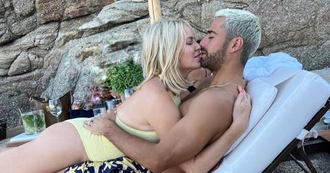 (l-r): Caroline Stanbury and Sergio Carrallo kissing outside in bathing suits.