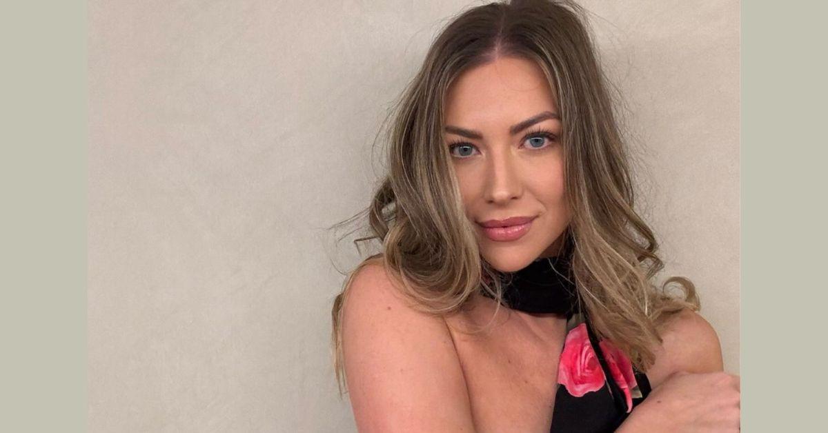 Stassi Schroeder poses for a photo in front of a wall