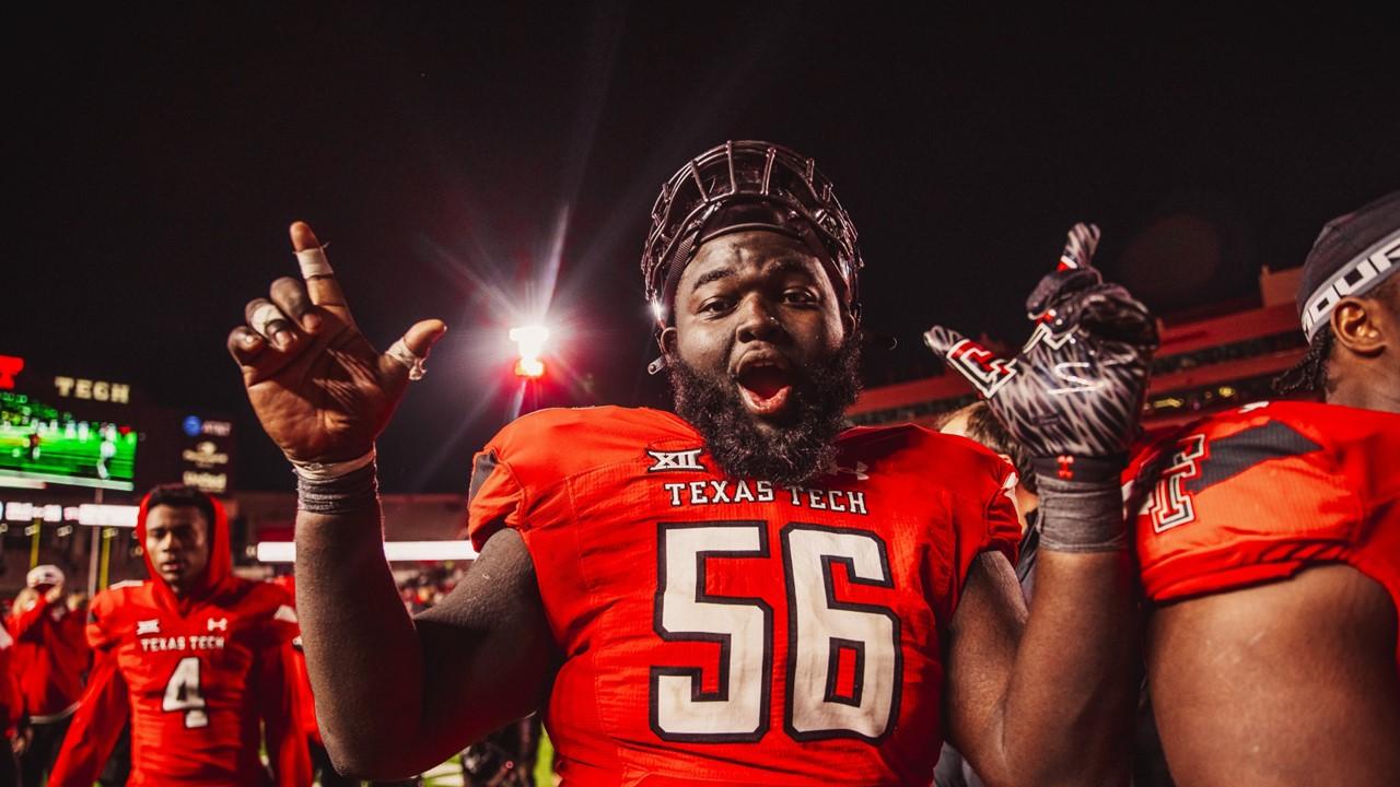 Texas Tech football players on the field after a game in November 2023