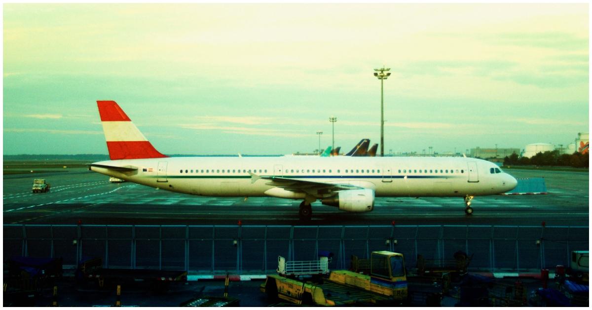 An airplane outside of the runway.